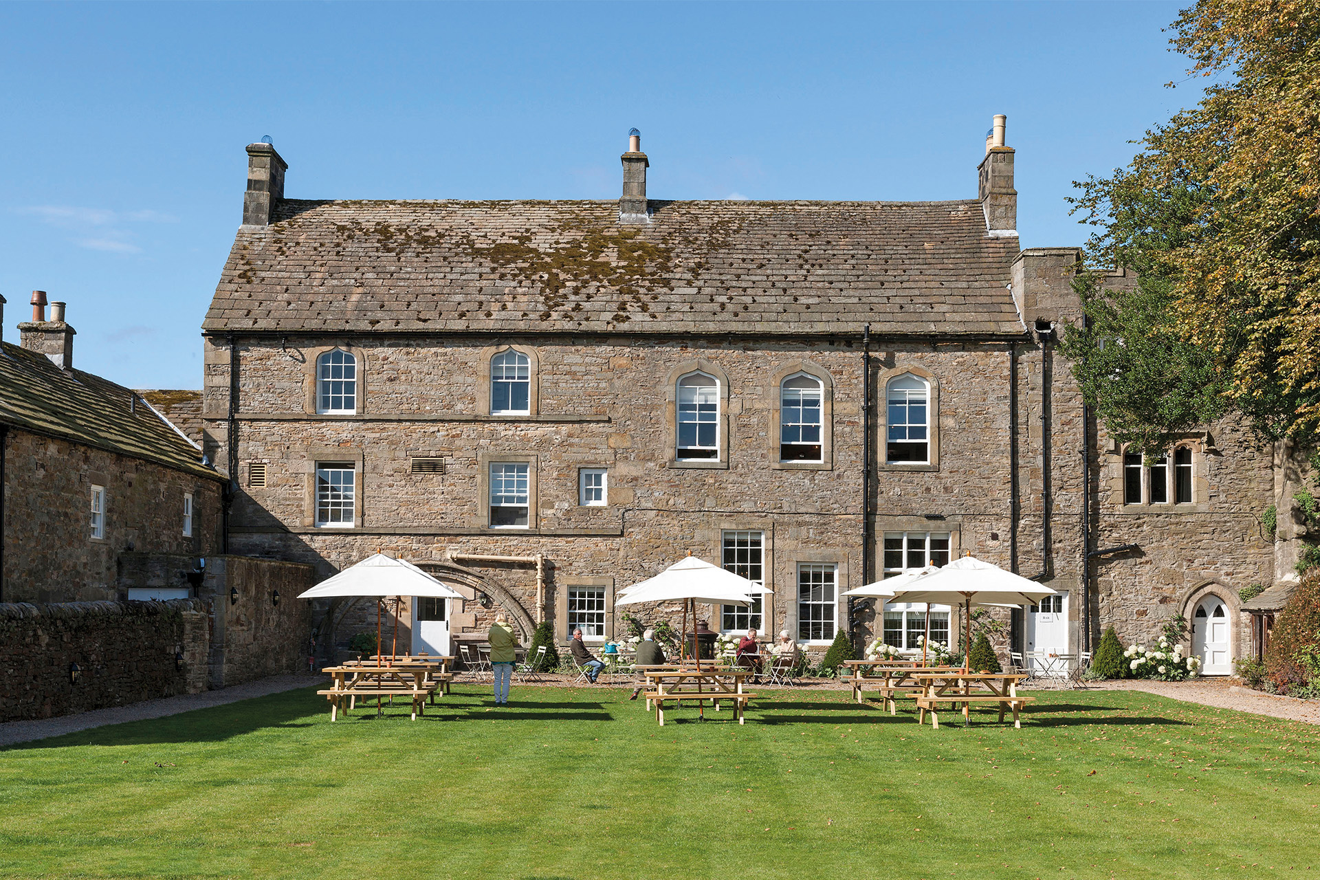 Exterior of country house hotel with lawn in front