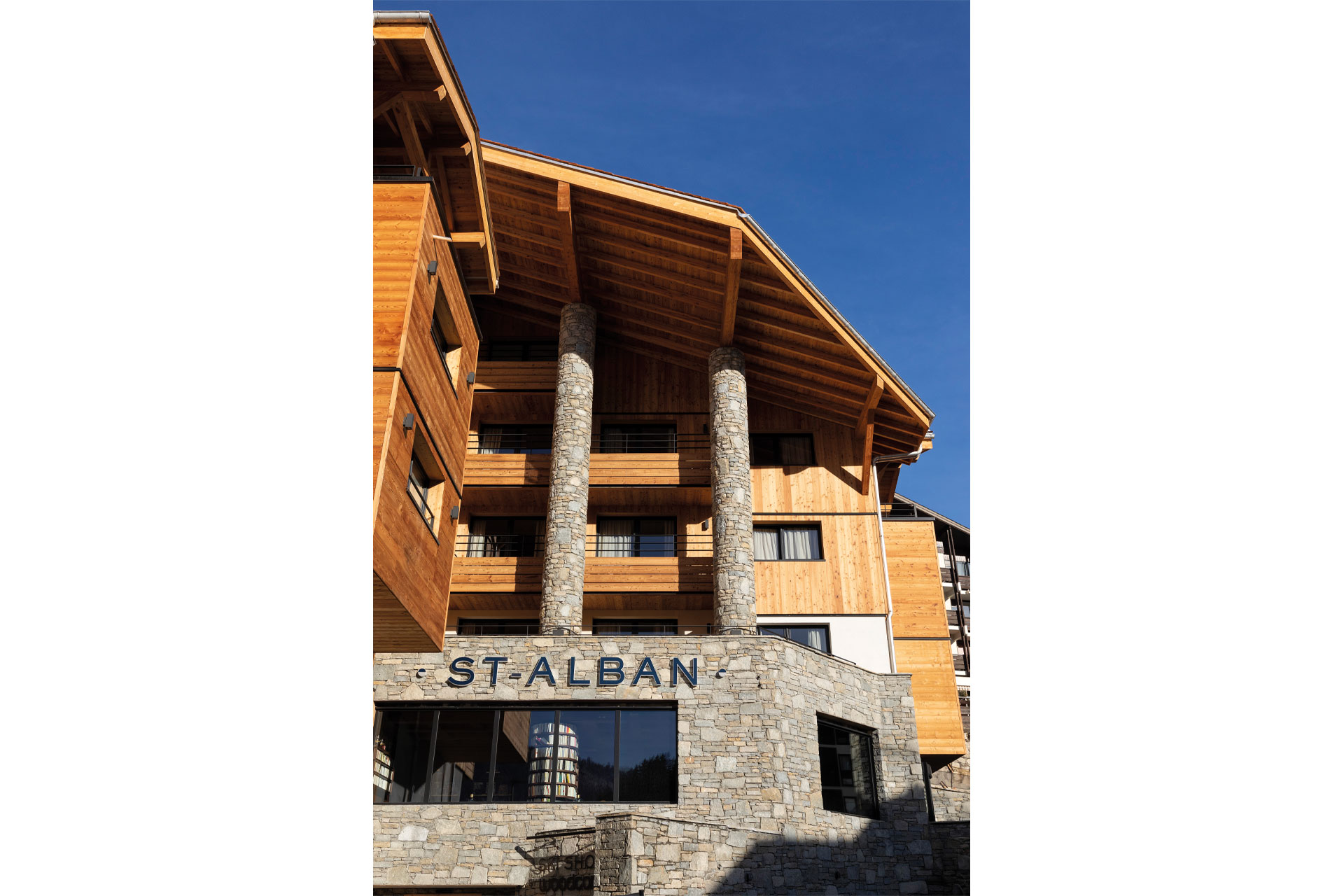 The exterior of hotel St Alban, with sign reading its name on light grey stone walls