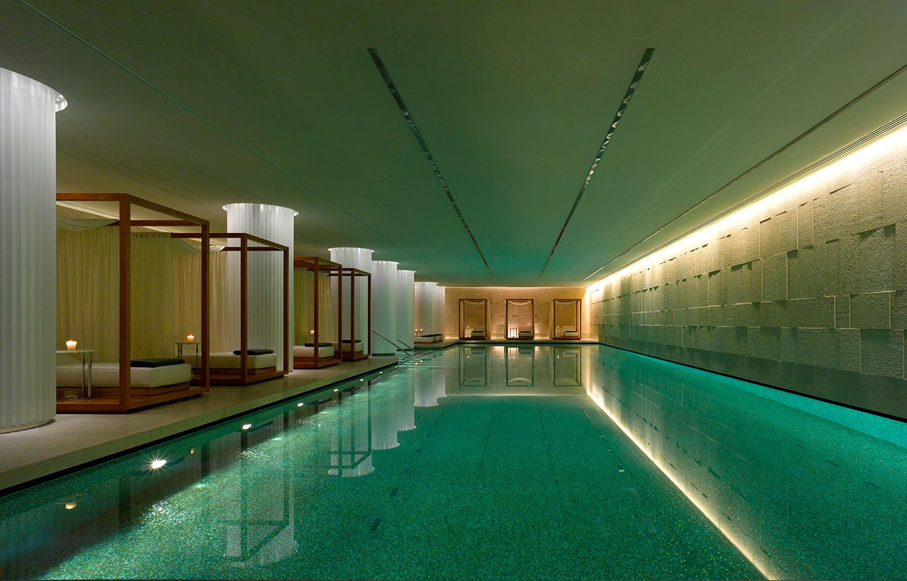 Indoor pool with beds to the side