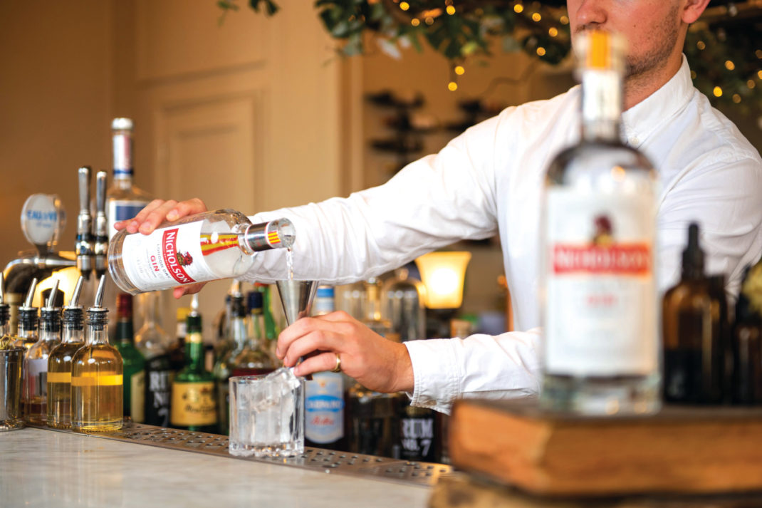 Barman pouring drinks
