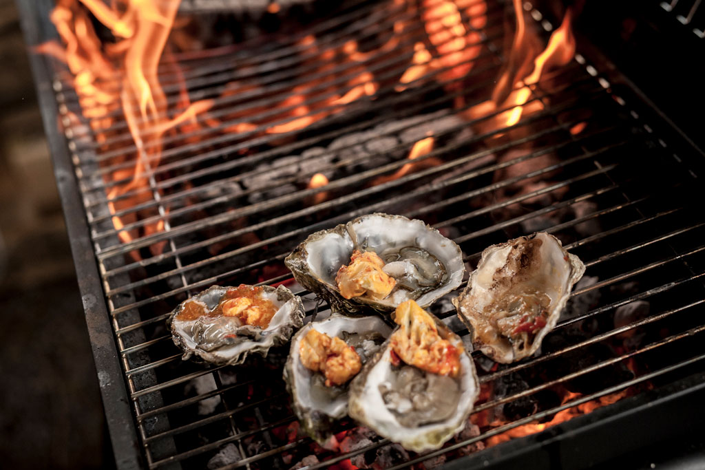 Oysters cooking on a fire