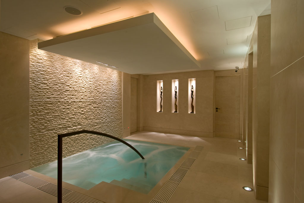 Indoor jacuzzi pool with golden stone interiors