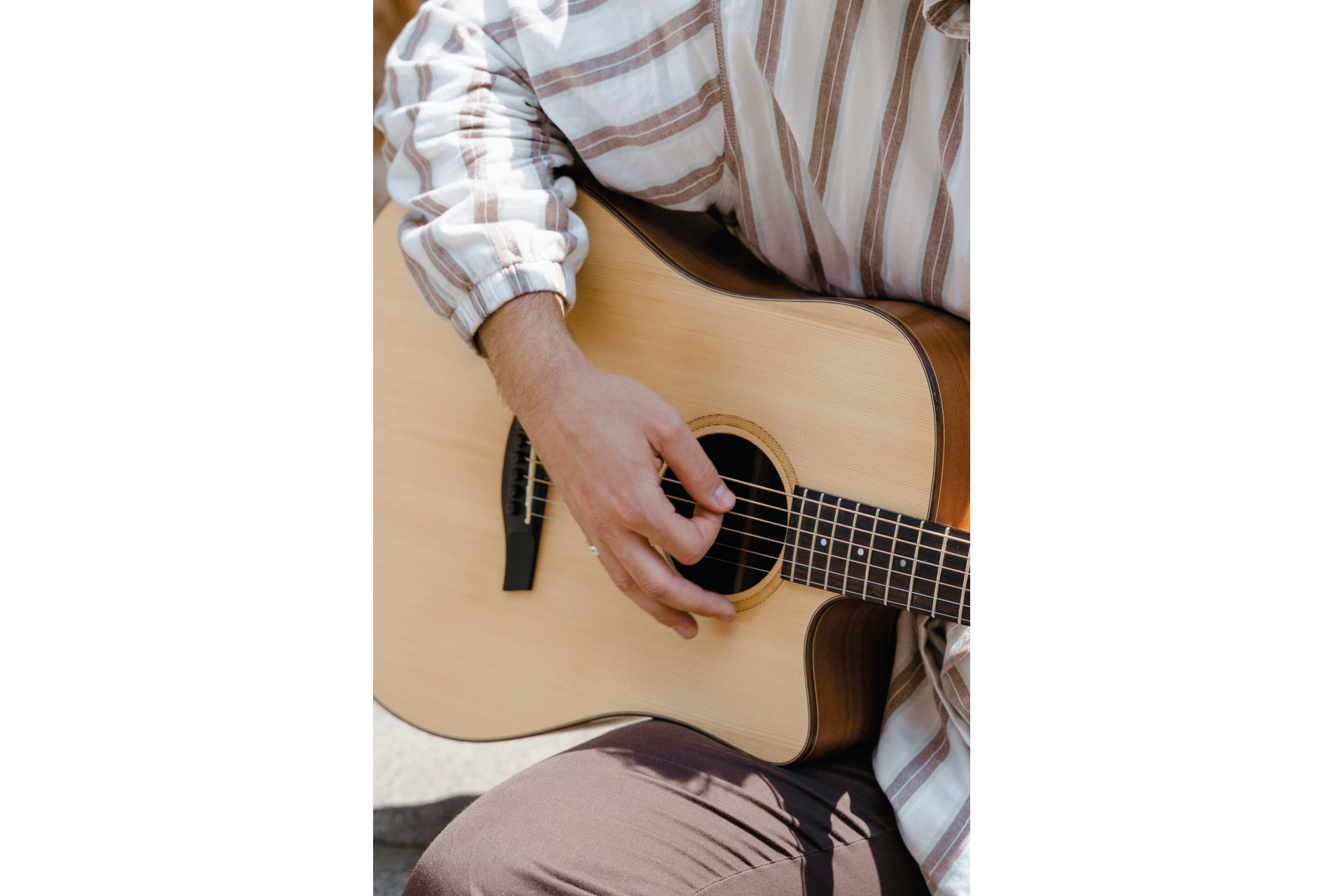 Close up of person playing guitar