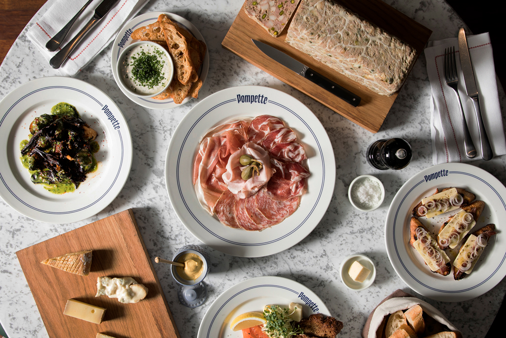 Small plates on a table at Pompette restaurant