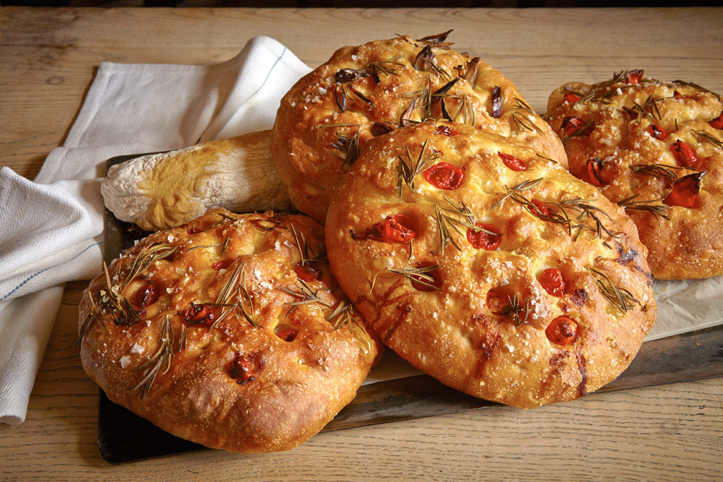 A bread board with focaccia