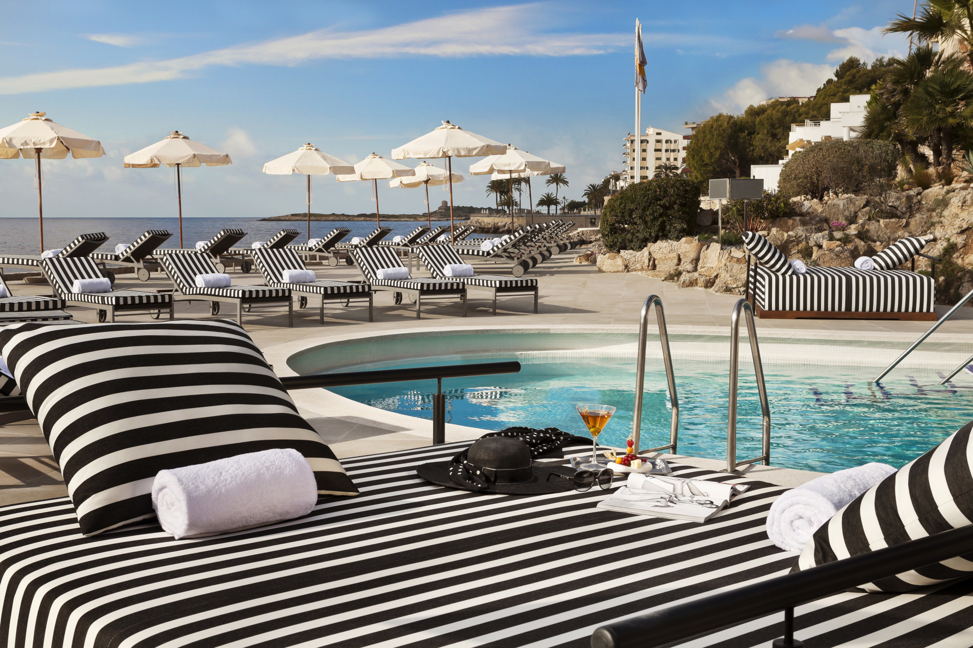 Black and white striped sun lounger by the pool