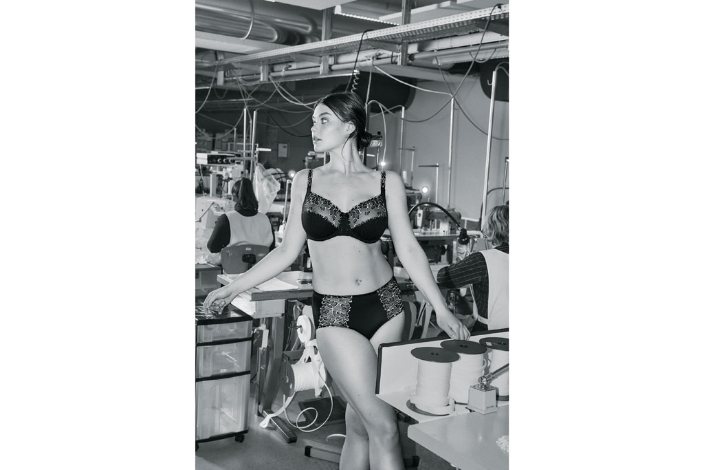 Woman stood in factory wearing lingerie