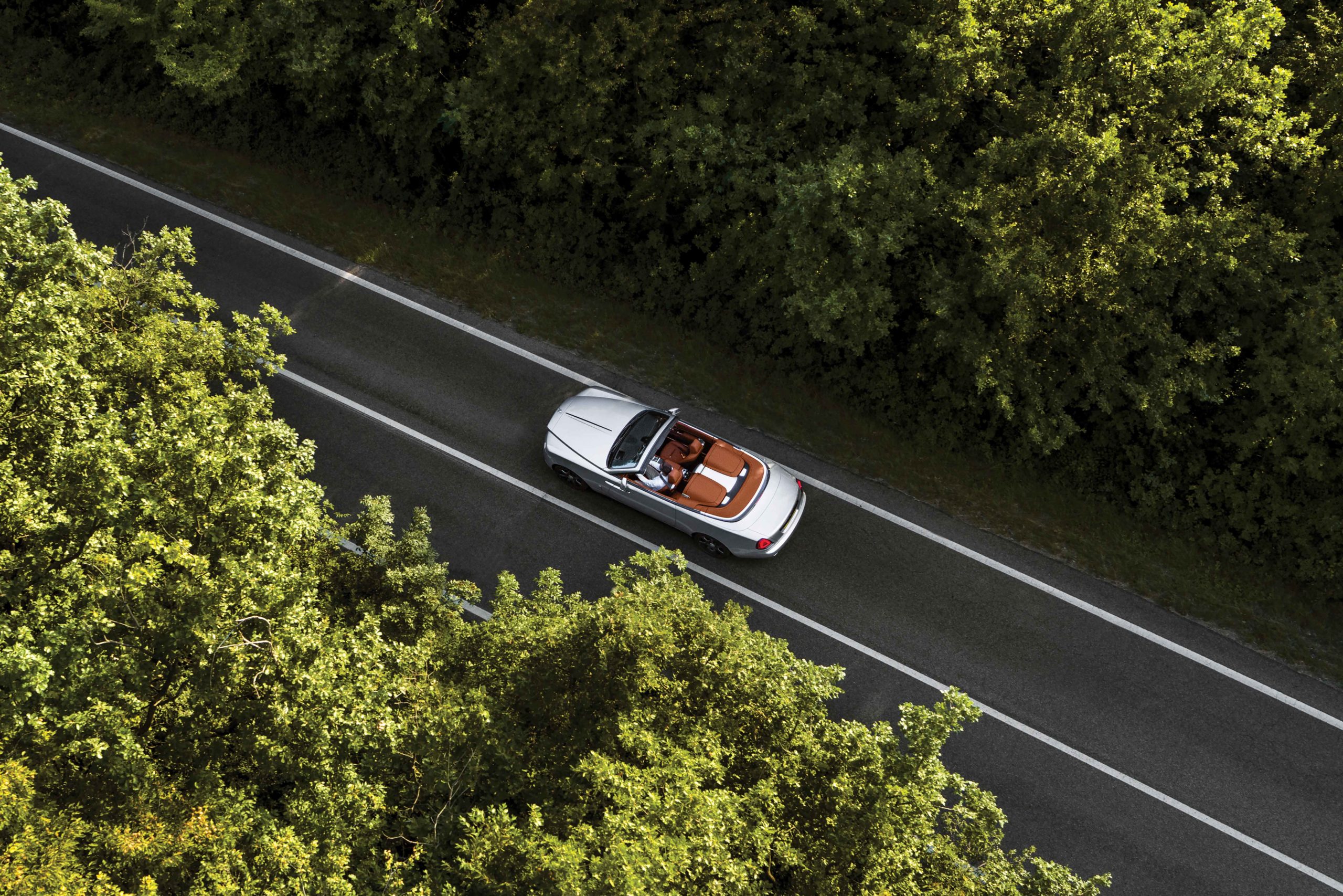 Rolls Royce silver open top convertible on road