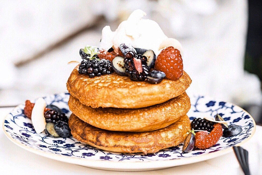 Stack of pancakes with fruit on top