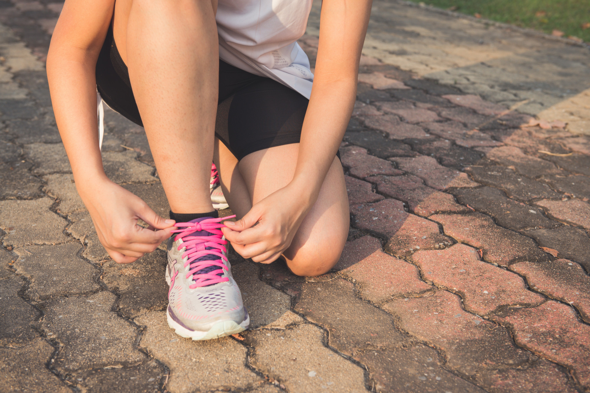 Woman lacing up trainers