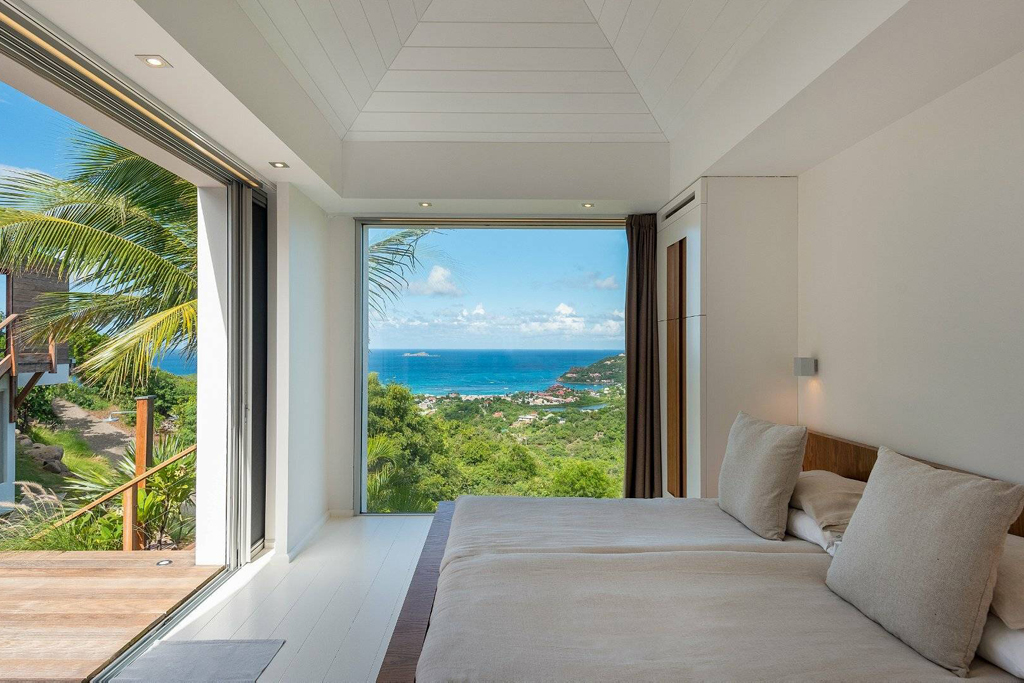 A bedroom window overlooking a bay