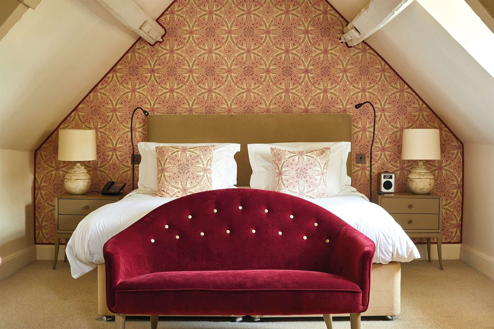 Red sofa in bedroom in Dormy House hotel