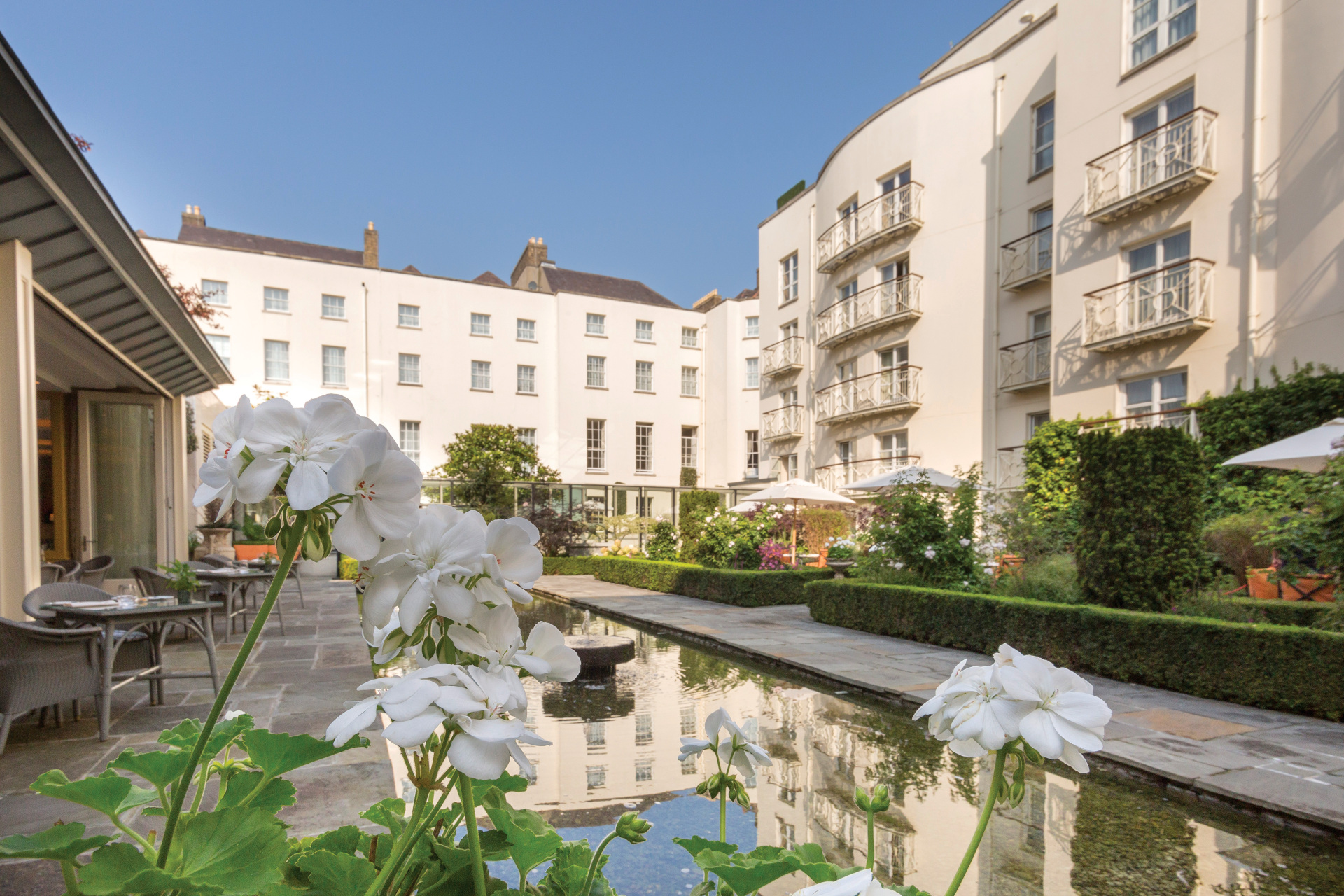 View of the exterior of the hotel over a water feature