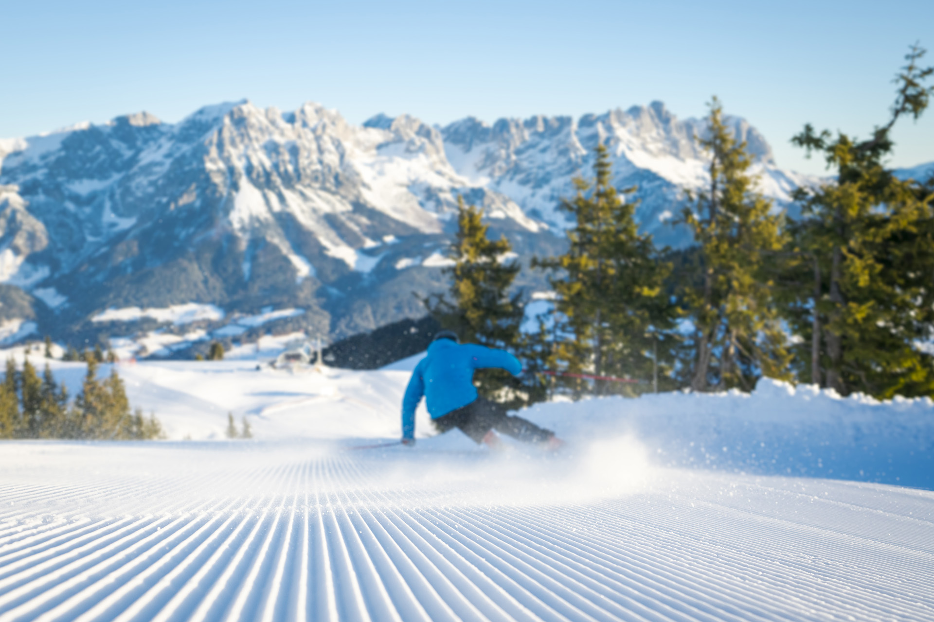 A man skiing down a freshly groomed slope in Austria