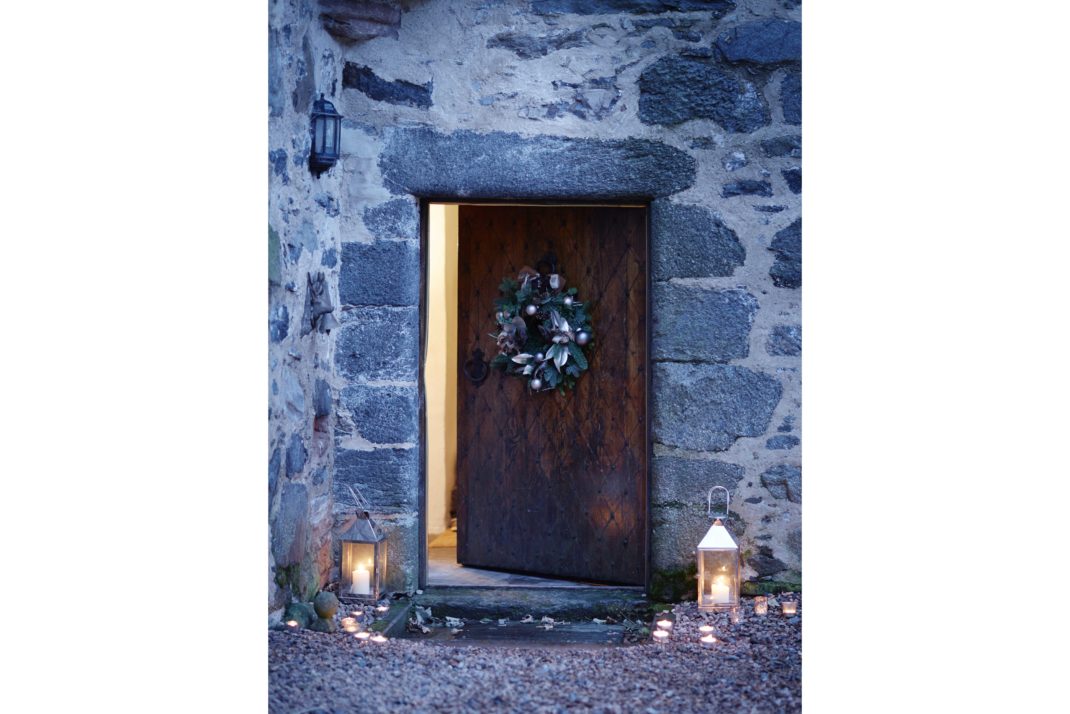 Forter castle front door decorated with wreath and candles
