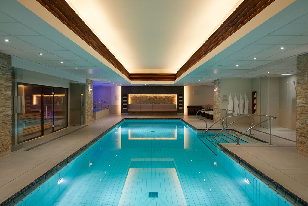 Indoor swimming pool flanked by showers and sauna rooms