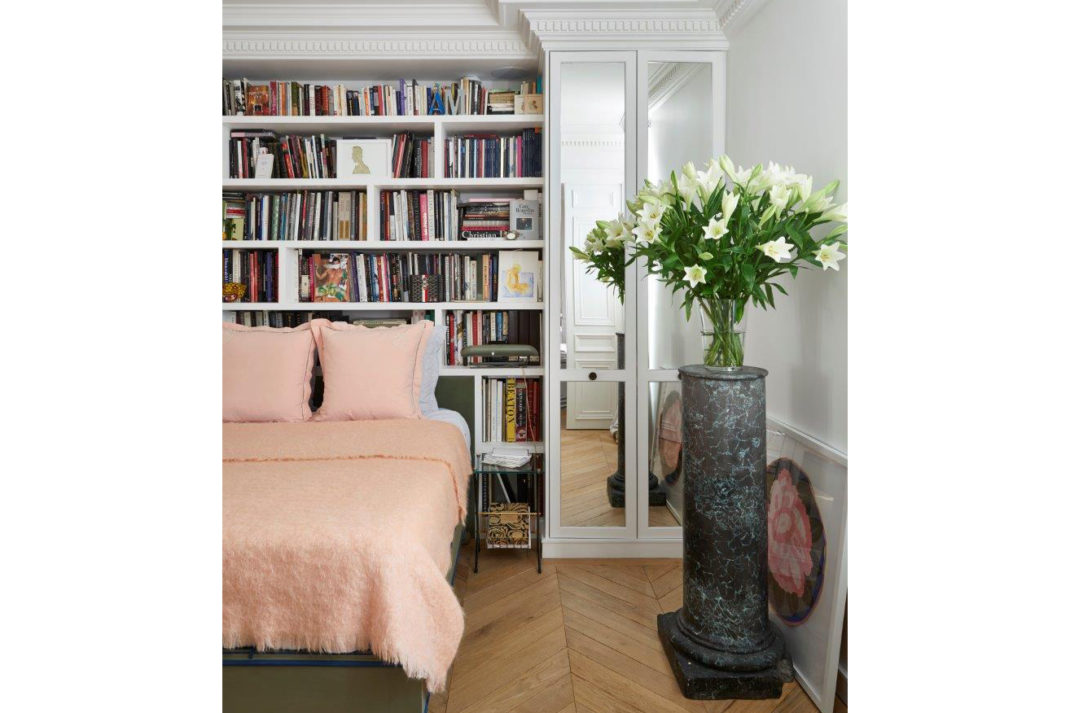 Parisian bedroom with book case and pink bed