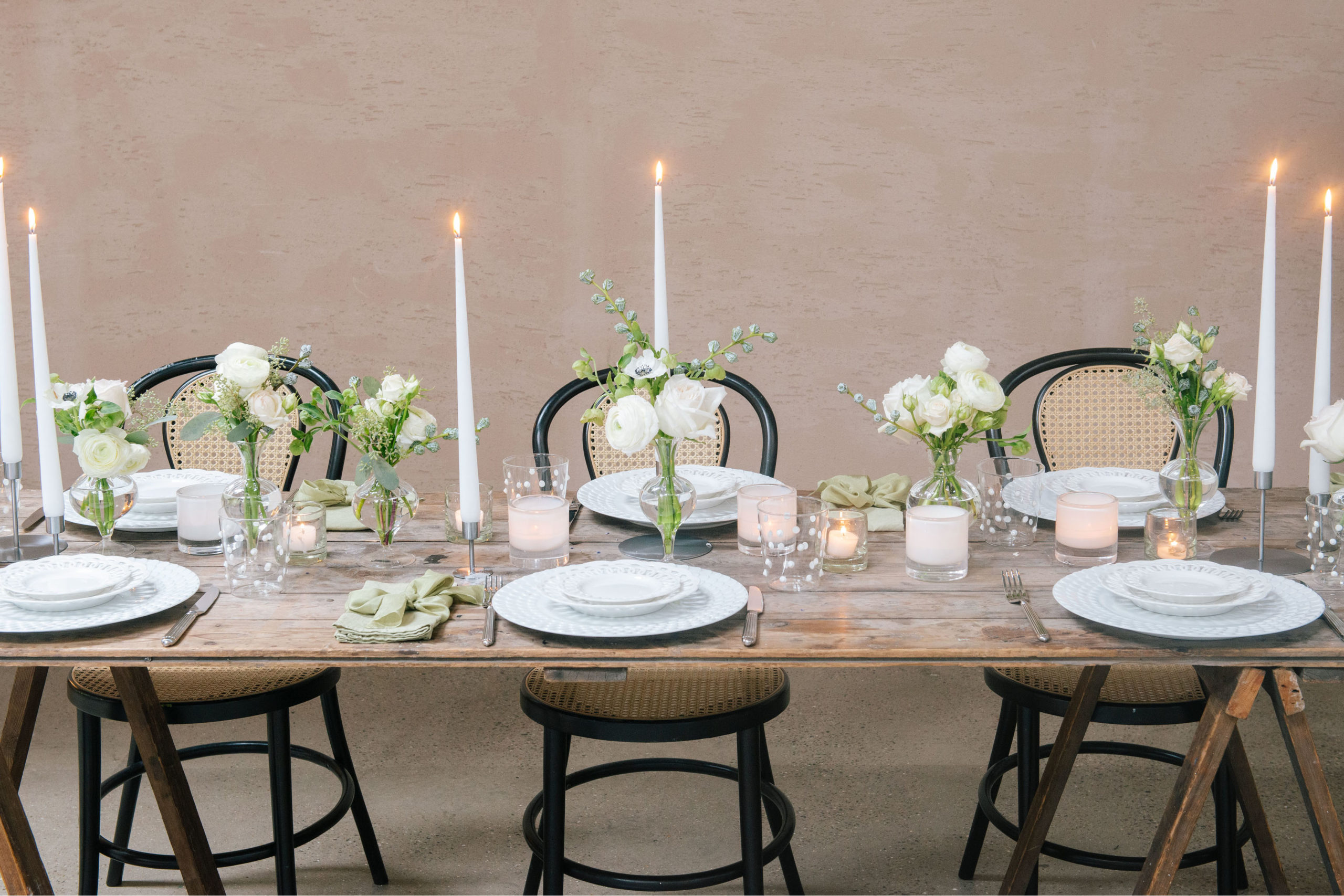 Nikki Tibbles minimal Christmas table setting with candles, greenery and wooden table