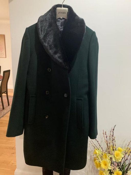 Green coat hung on wall