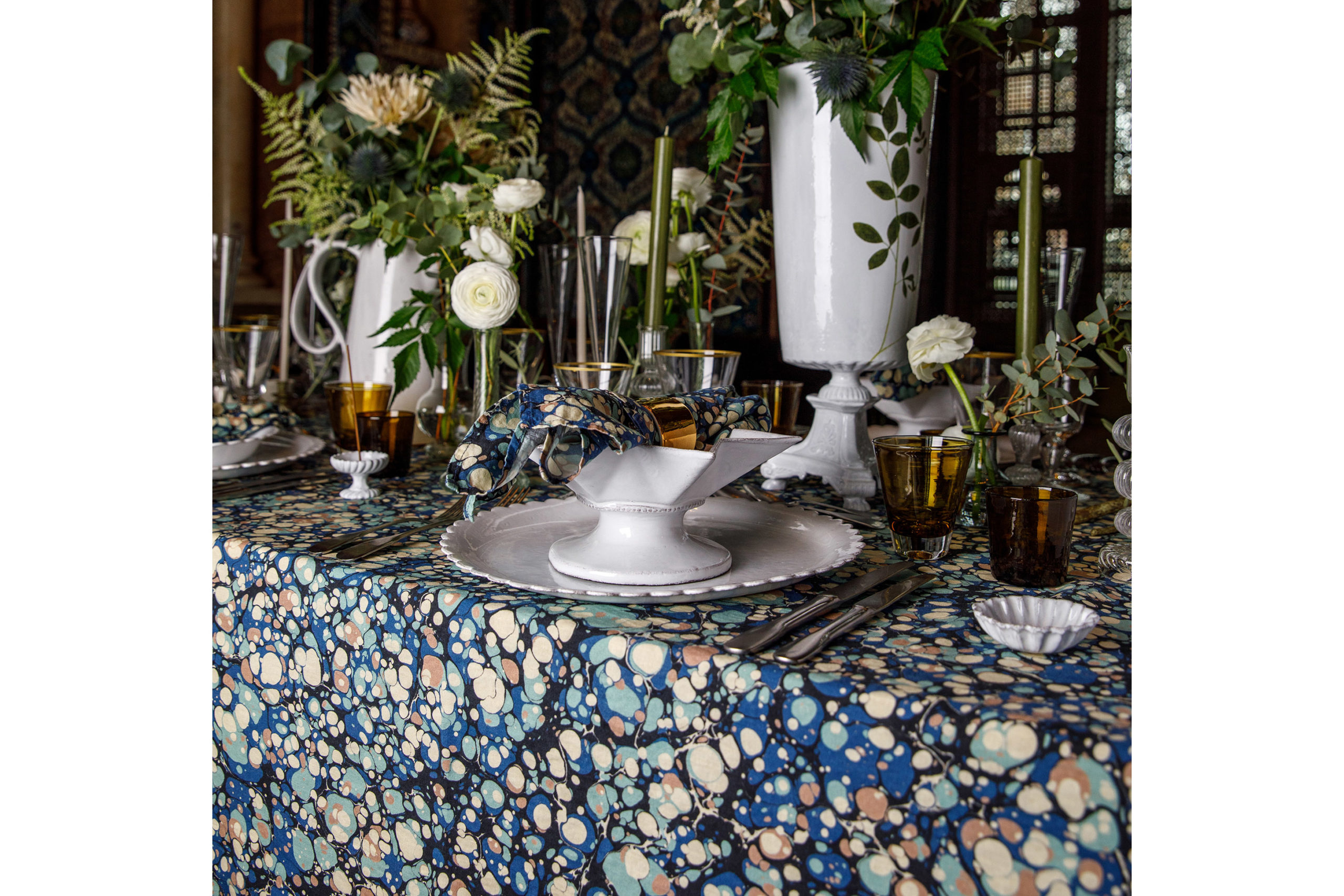 Summerill & Bishop x matchesfashion blue and green marbled tablecloth under floral-decorated tablesetting