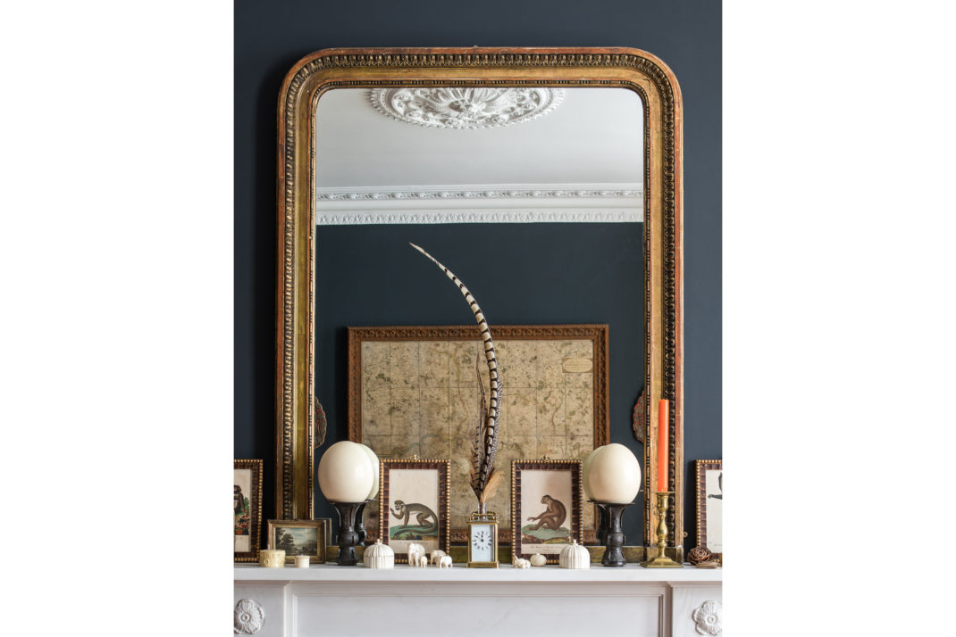 Gold mirror on mantlepiece