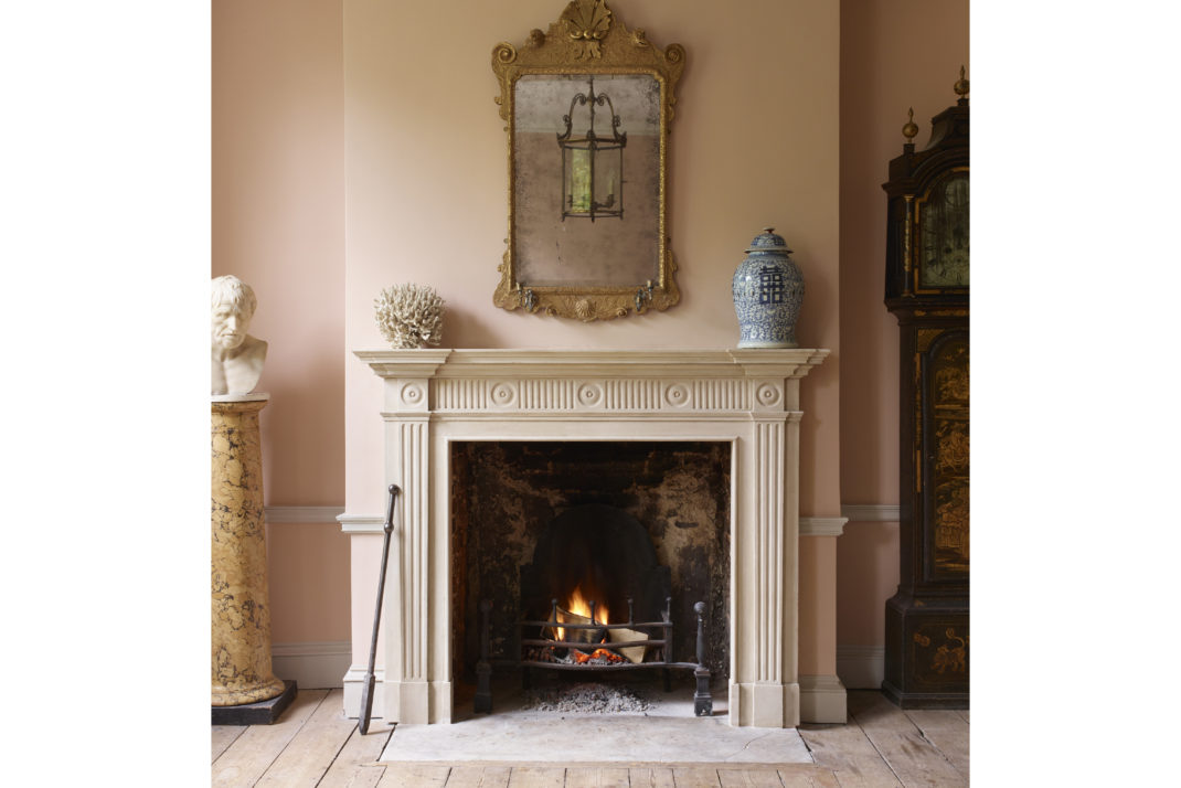 Jamb Georgian fireplace with mirror hanging above 