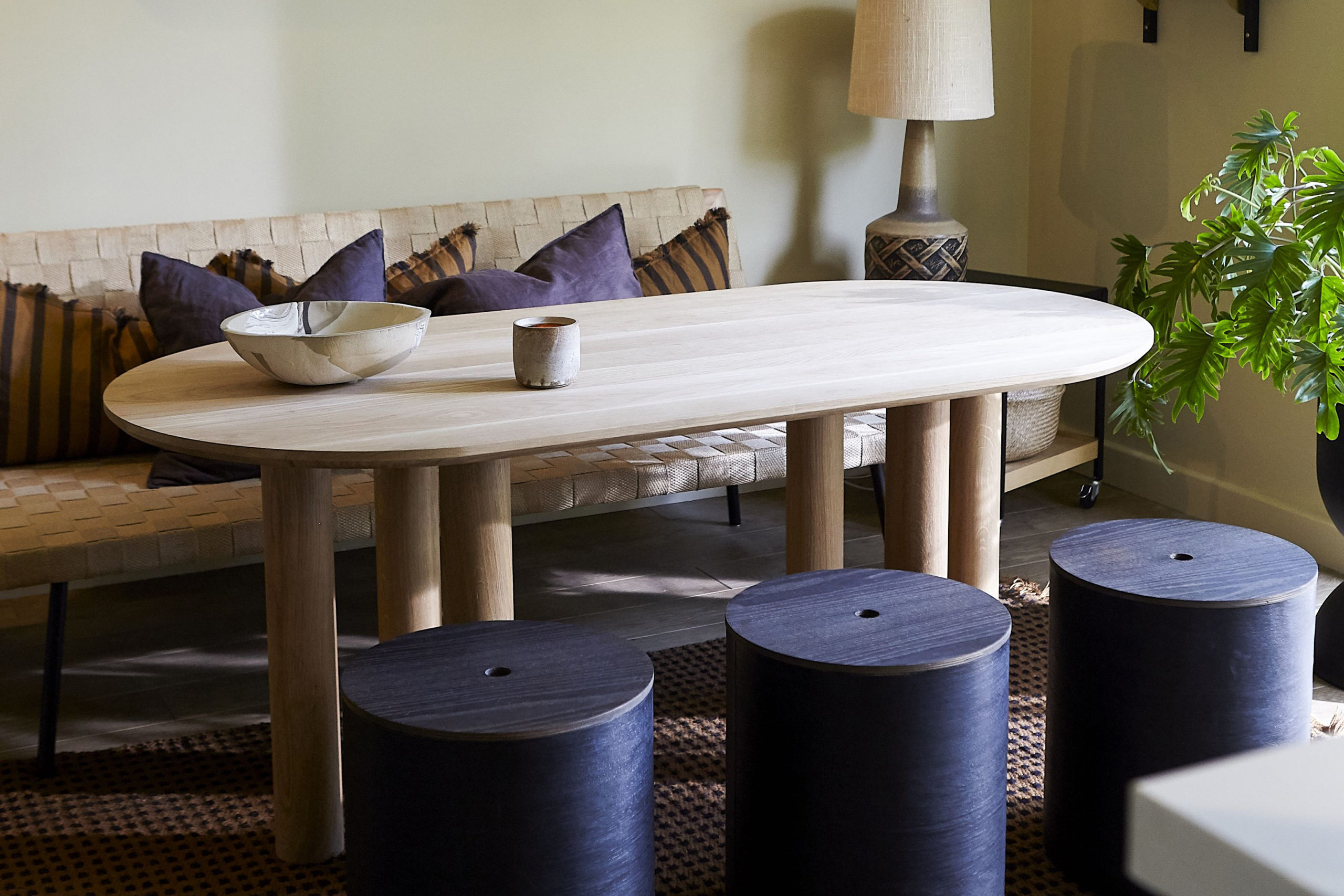 Earl of East wooden table with blue stools