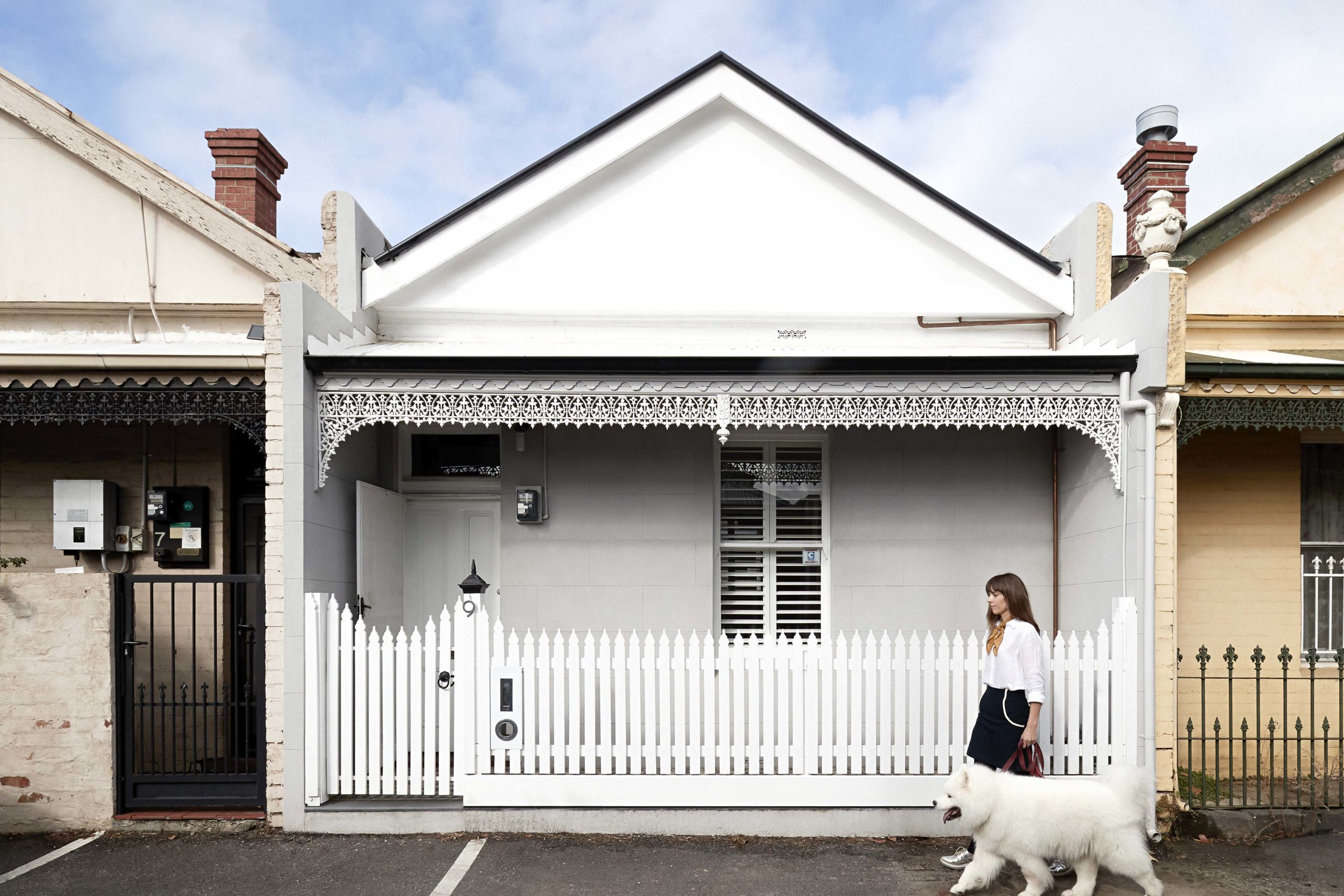 White miniature terraced house with picket fence in Melbourne, Australia