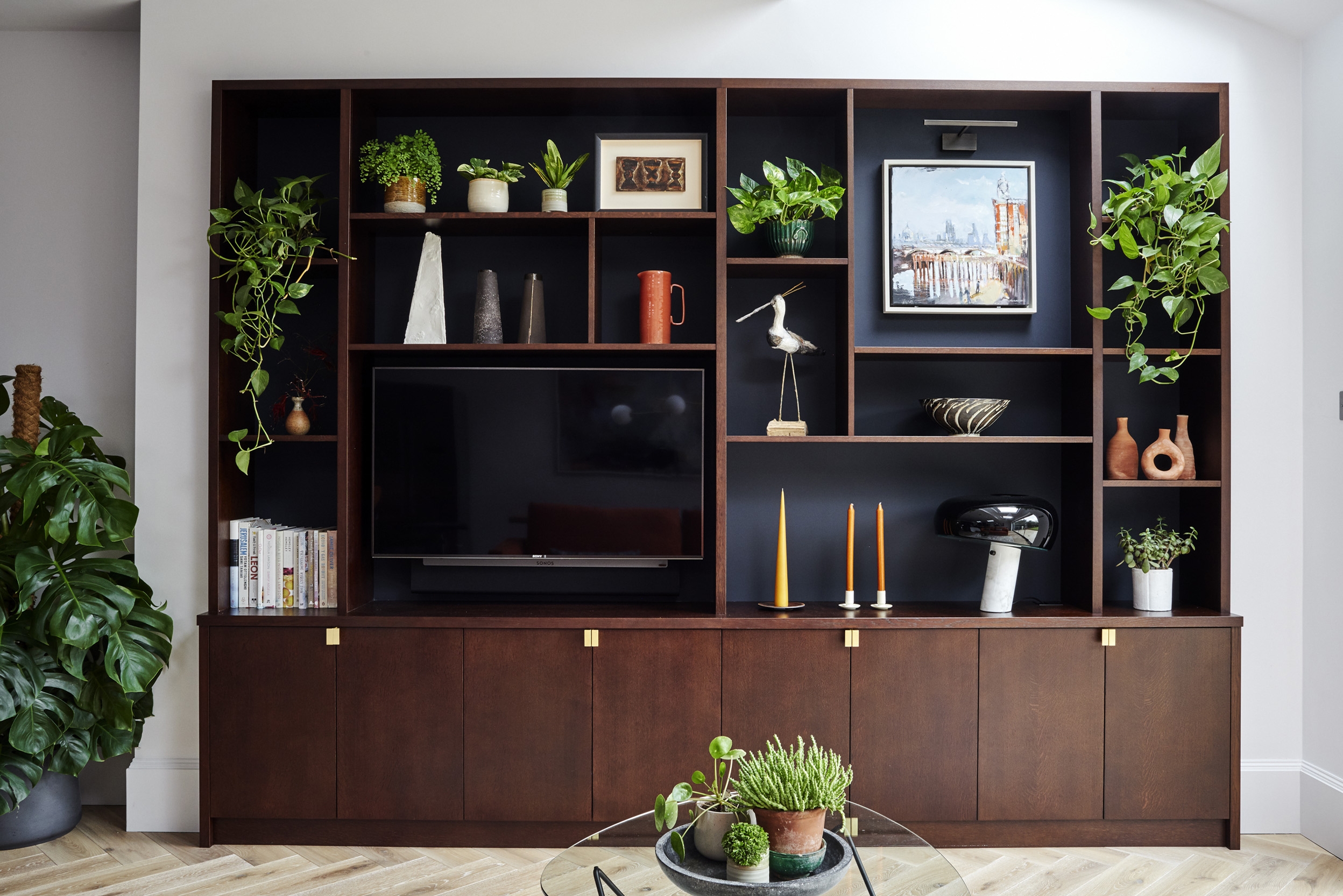 Wooden shelves with plants, ceramic, artwork