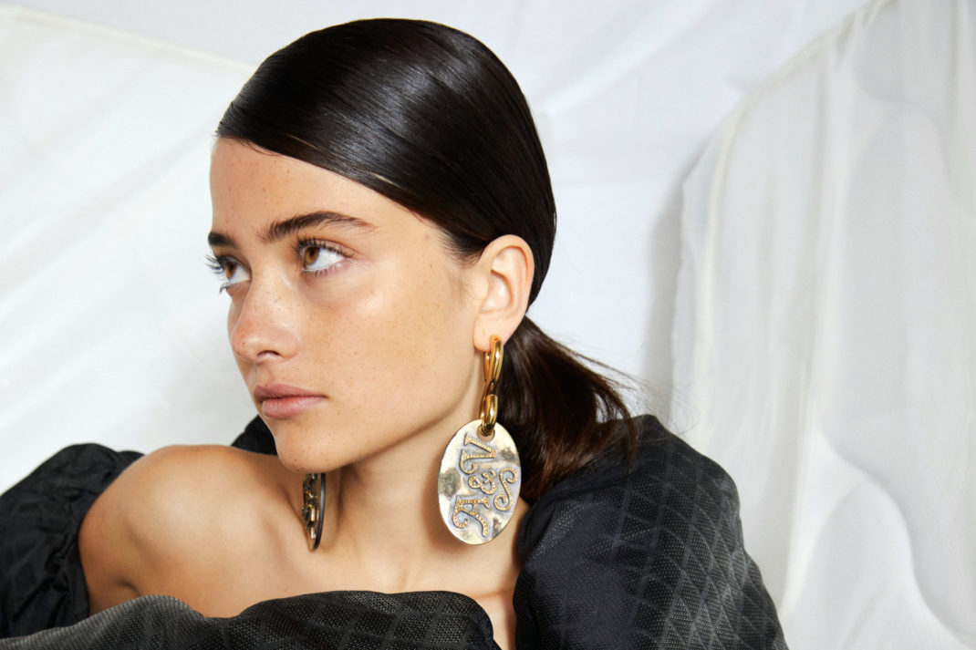 Model with oversized earrings