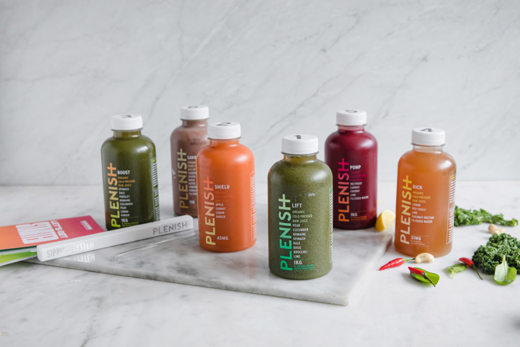 Plenish - juice bottles lined up against marble background (healthy meal delivery services)