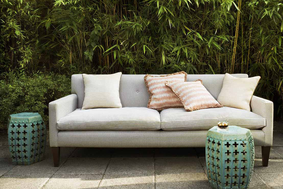 George Smith grey sofa outdoors with patterned cushions