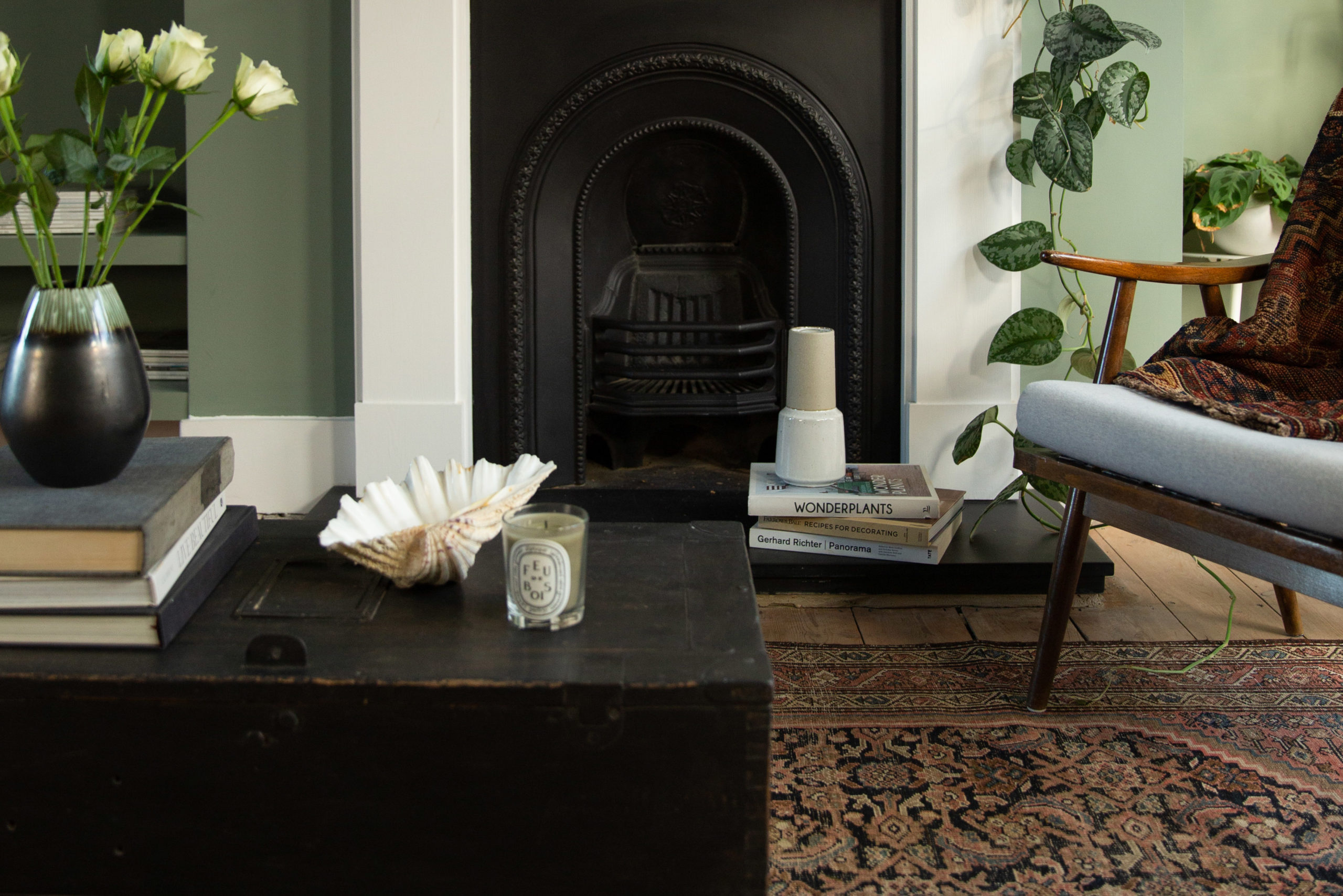 Fireplace with green walls, decor detail, modern, moroccan rug