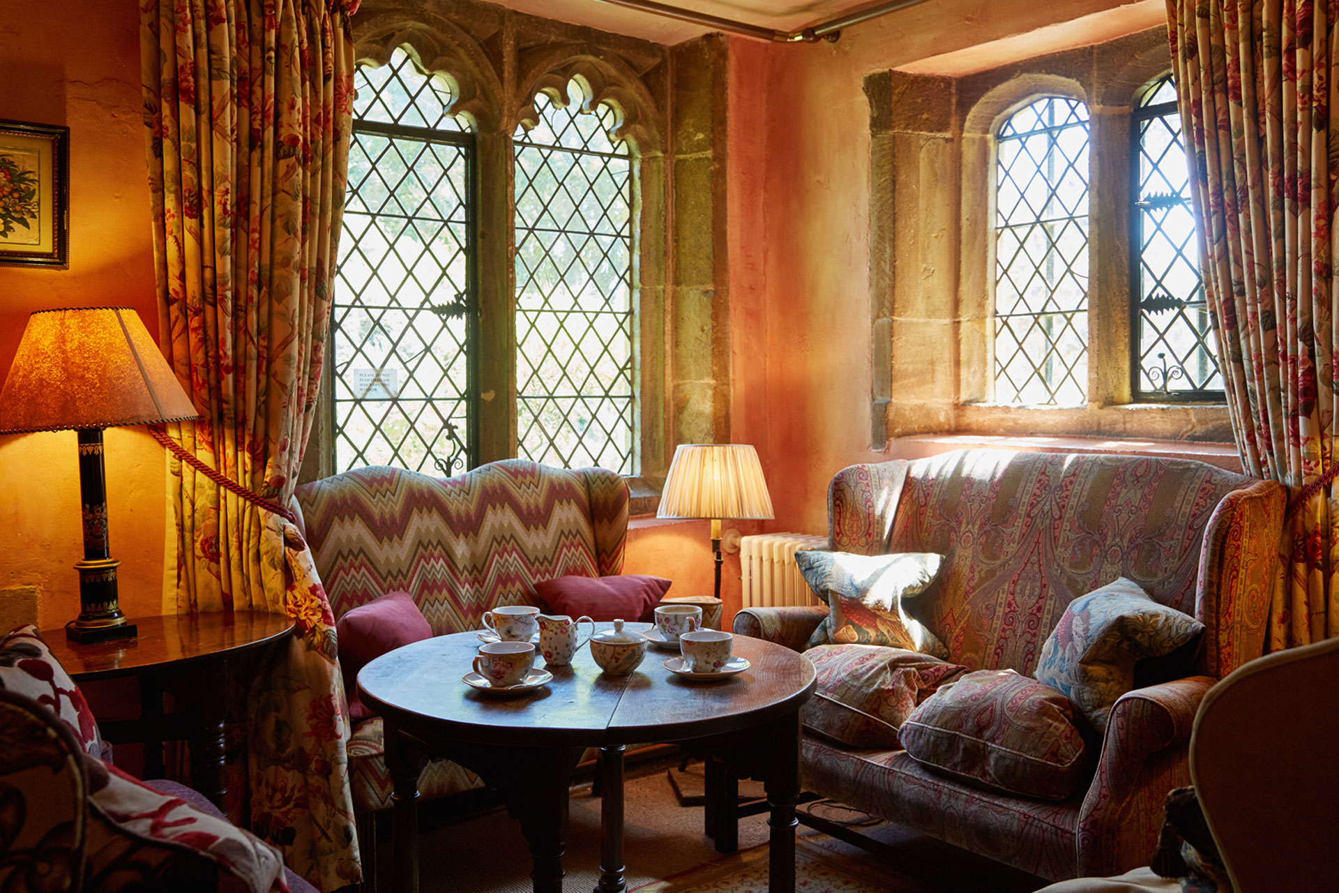 a cosy medieval living room with patterned sofas at Ballifscourt Hotel & Spa