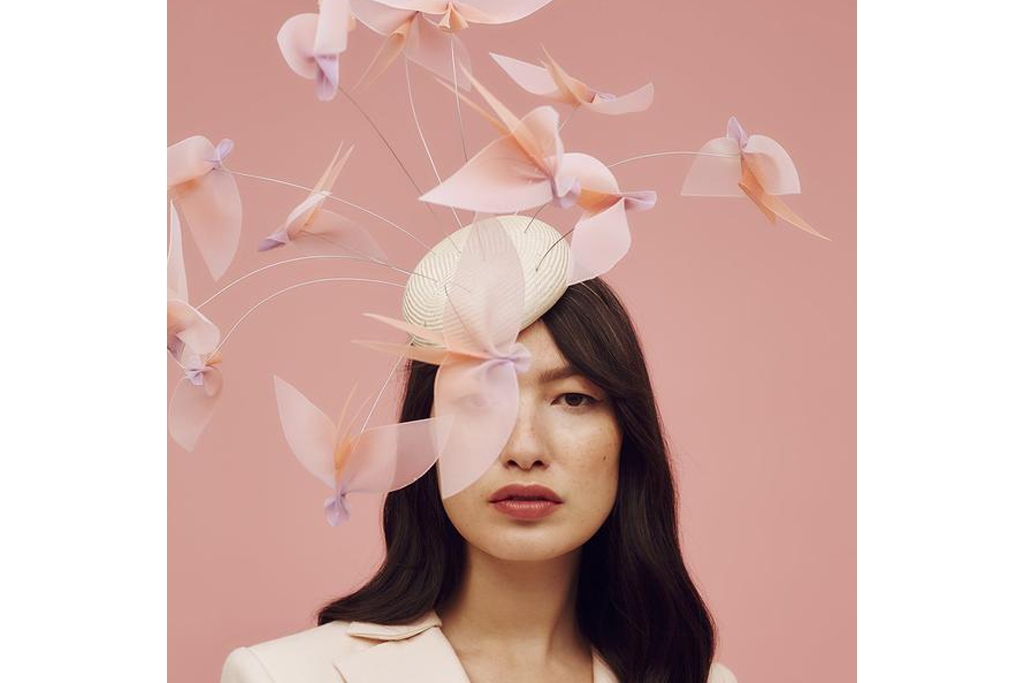 Woman in pink hat on pink background