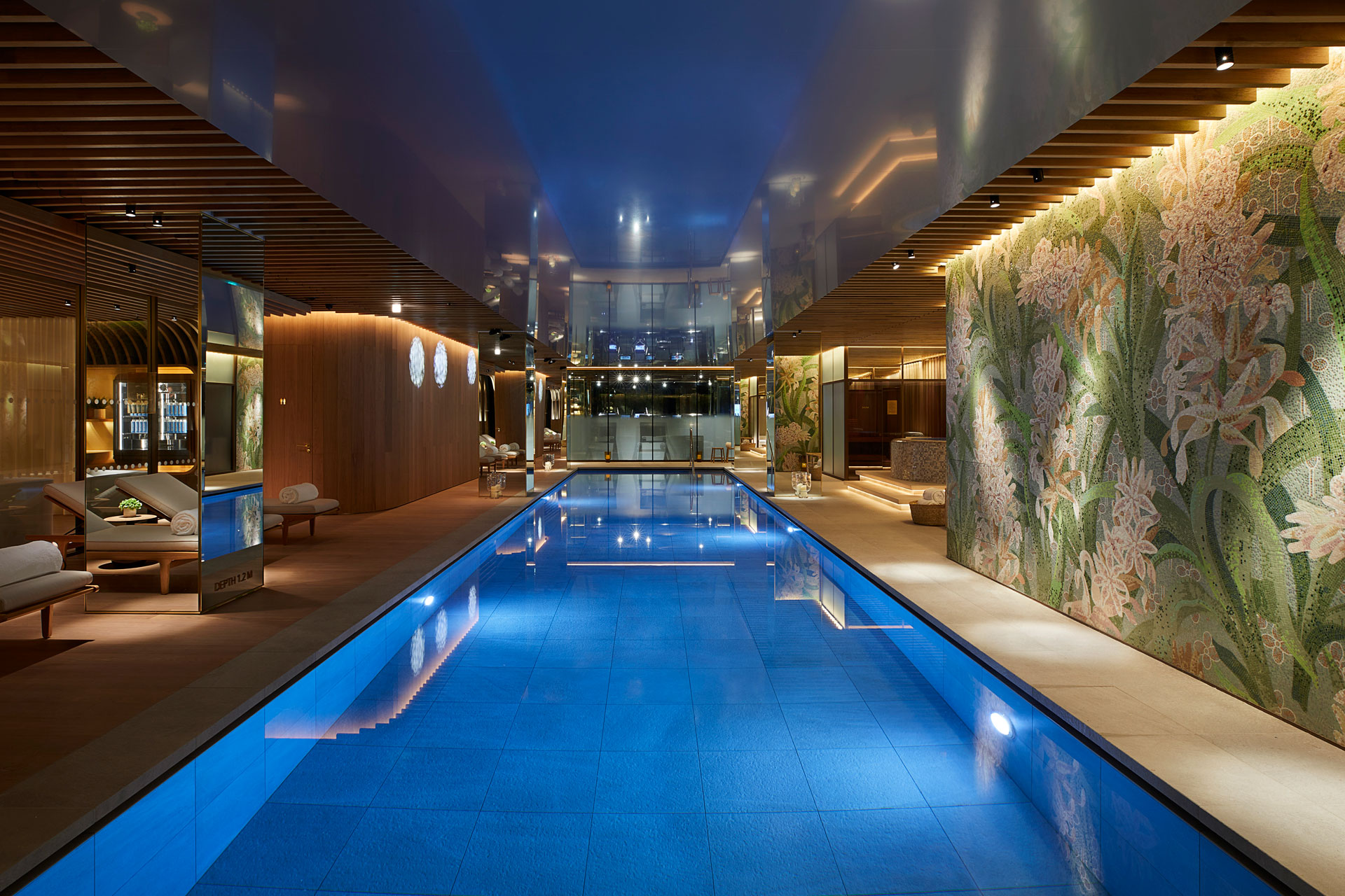 Blue indoor pool with floral murals on the walls and loungers to the side, The Spa at 45 Park Lane