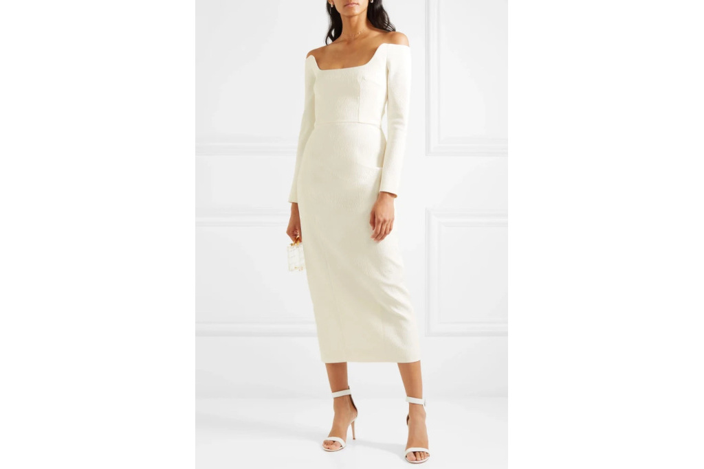 Model in white dress stood in white room