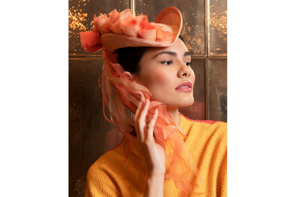 Model in orange with orange hat