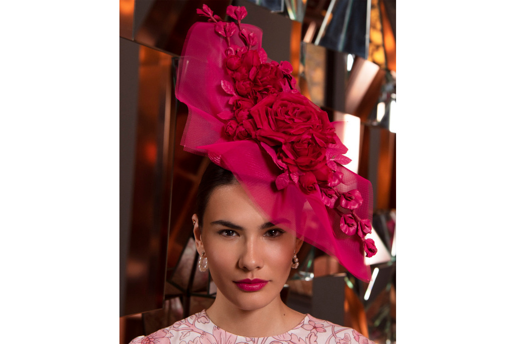 Model in dark pink floral headpiece