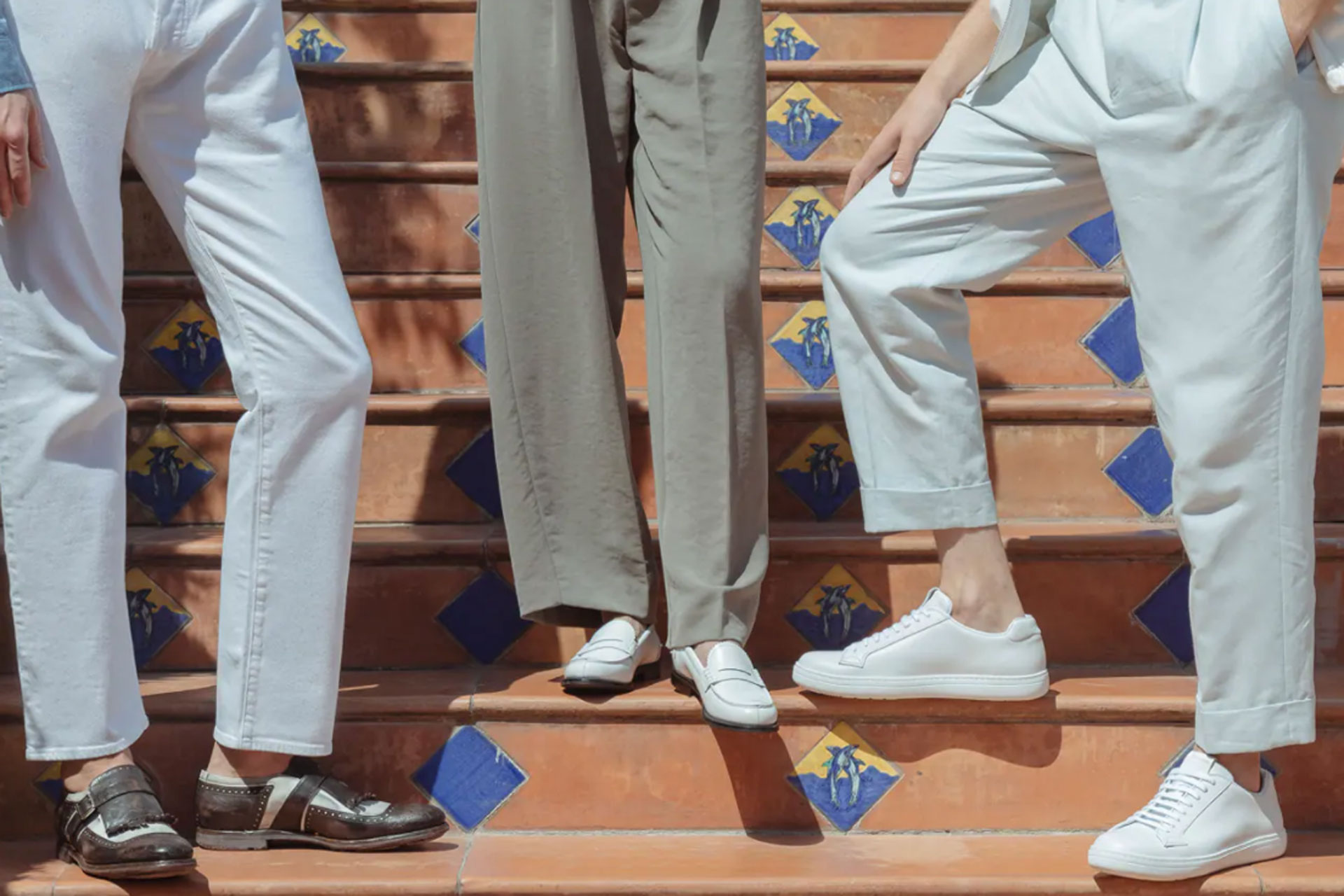 Close up of people stood on prange steps wearing neutral coloured shoes and trousers