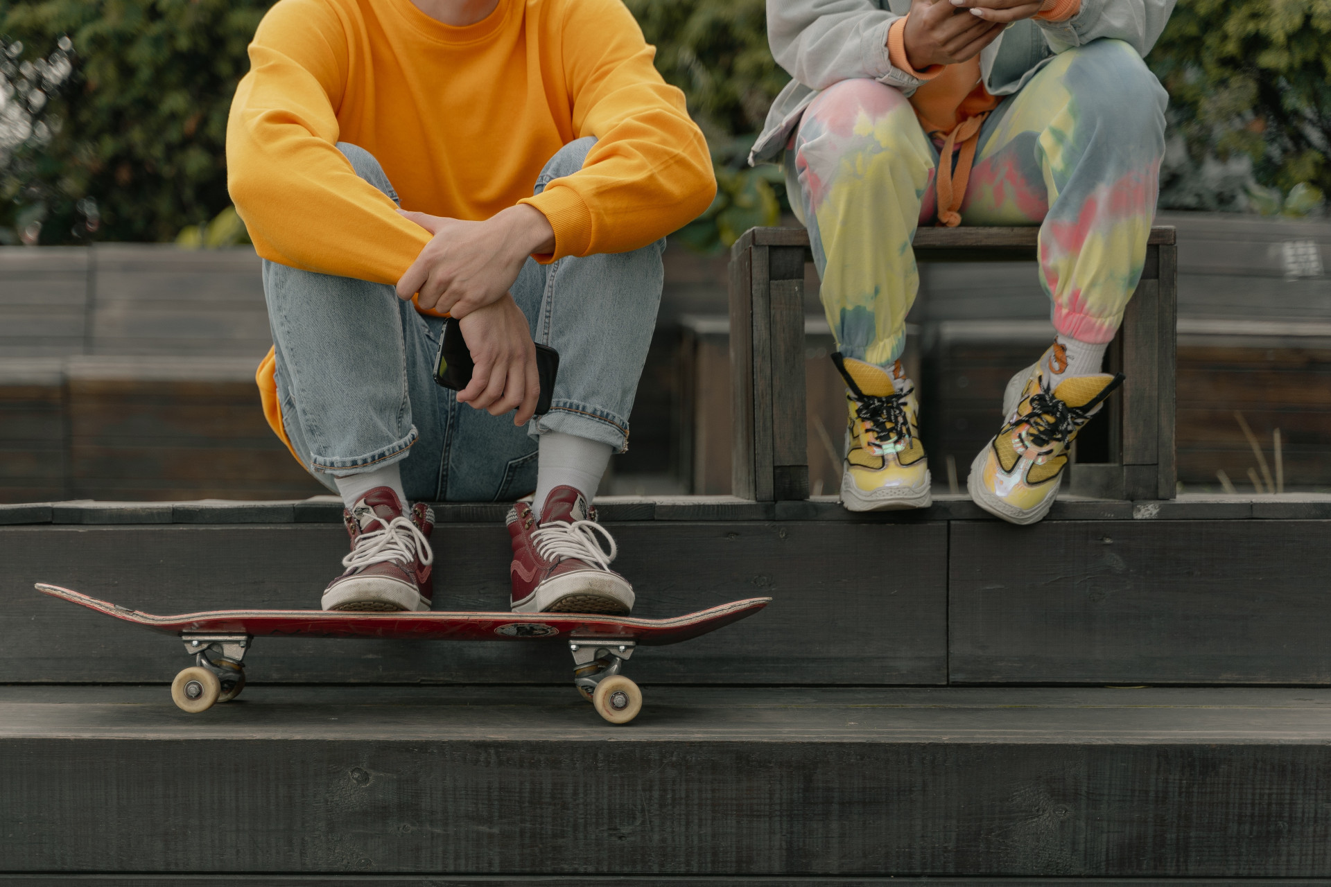 Two People Sitting on Wooden Stairs