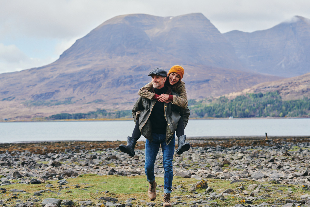 man giving woman piggyback in Scotland