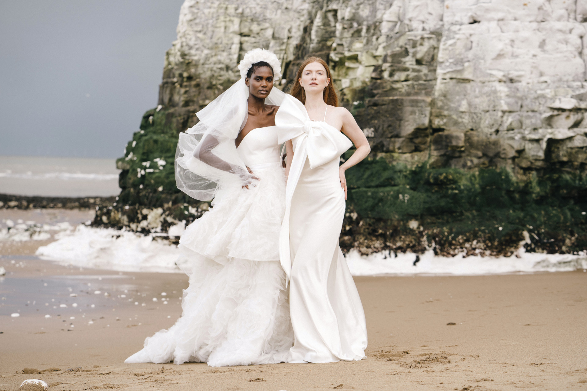 Models in wedding dresses on the beach