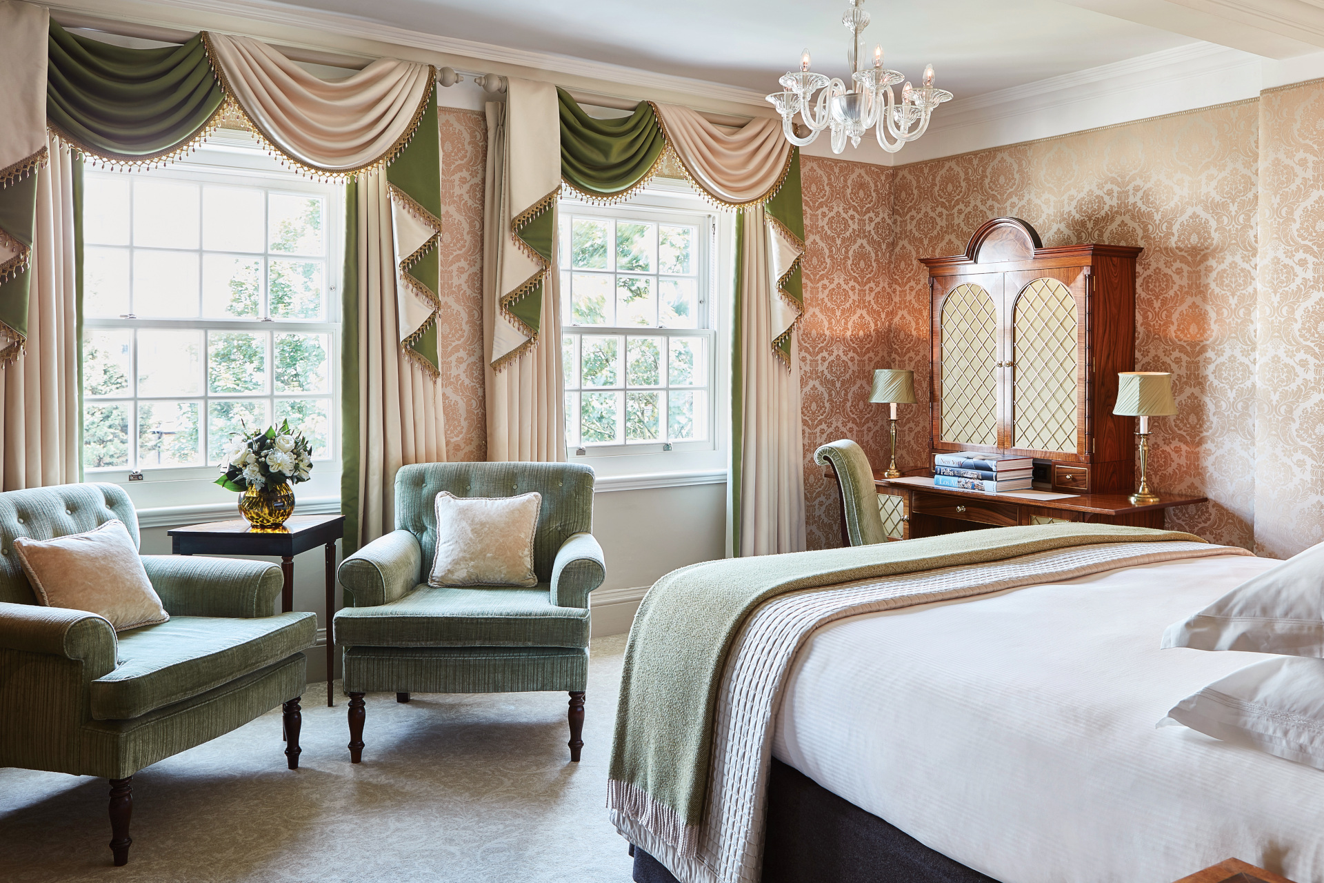 Hotel room with large windows and green curtains