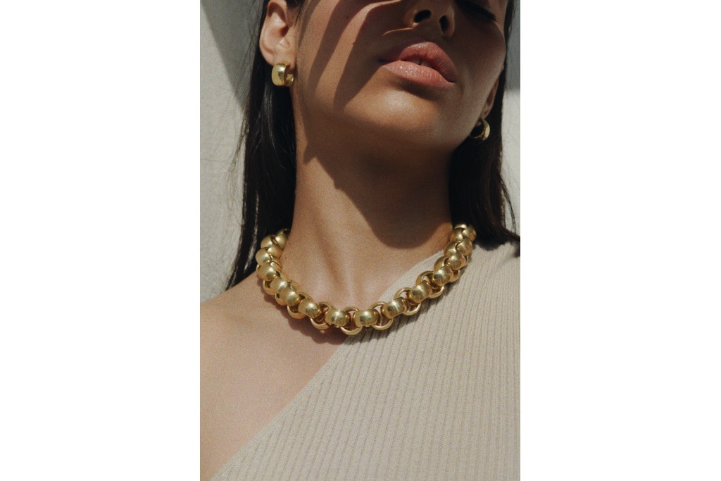 Laura Lombardi - model with gold necklace and earrings