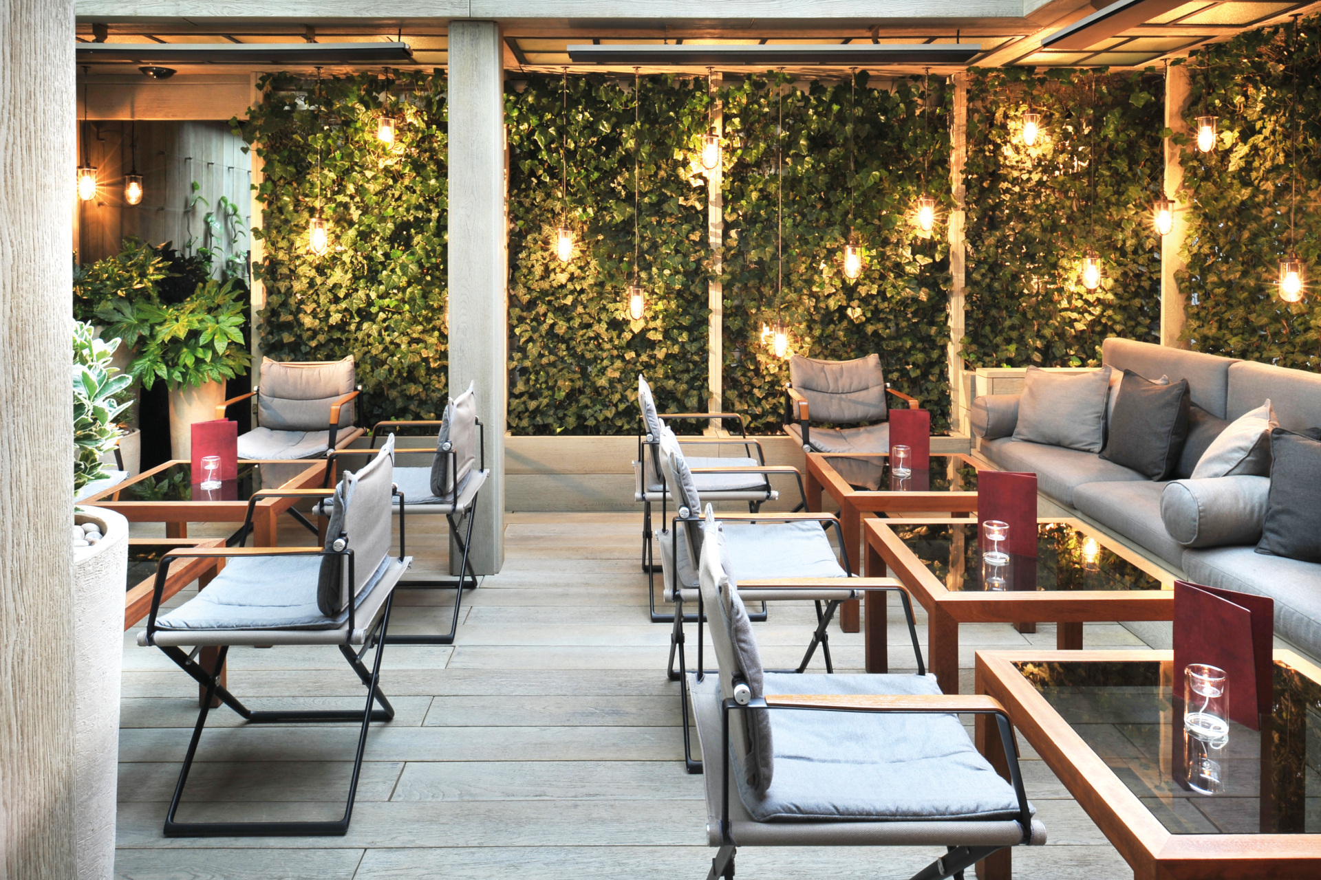 Outdoor terrace with dining area and fairy lights
