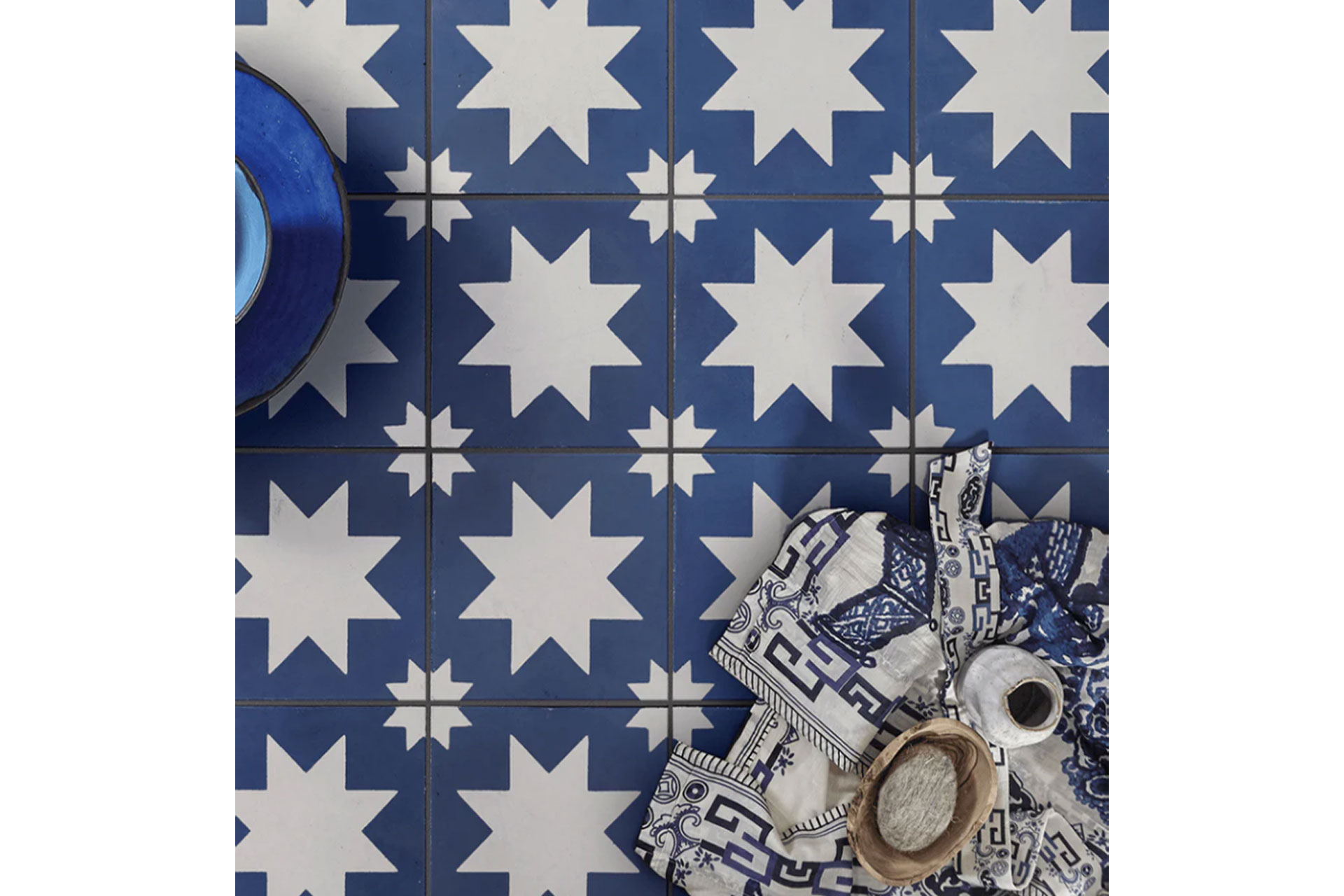 white and blue tiles with stars, created by Bert and May, are a british tile manufacturer