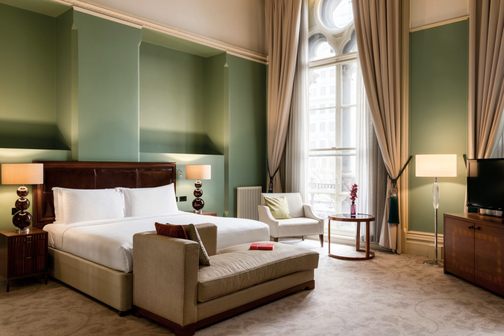Green hotel room with large windows