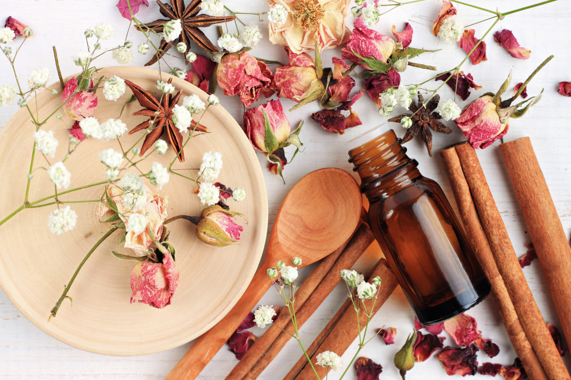 Top Ten Fragrances - rose petals and oils laid out on table