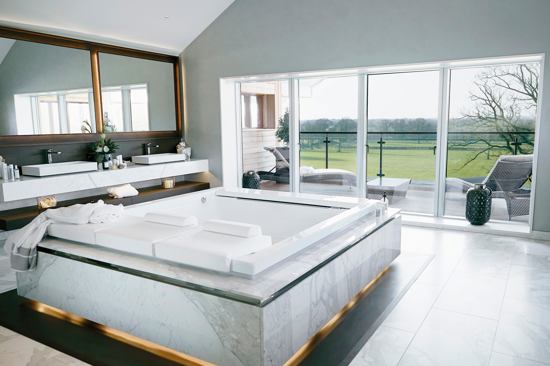 A large bathroom with spa bath by St James Interiors